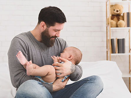father holding his crying infant