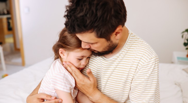 A mom holding a baby with pediatric diarrhea